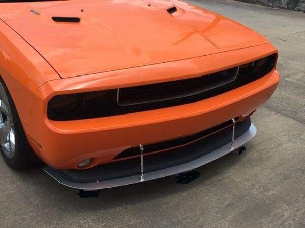 An orange sports car parked in a parking lot