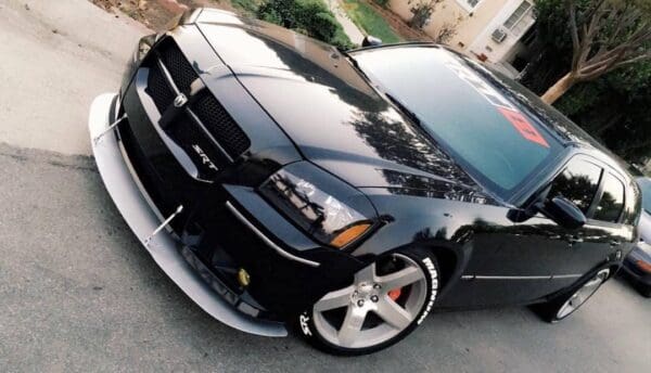 A black car parked on the side of the road