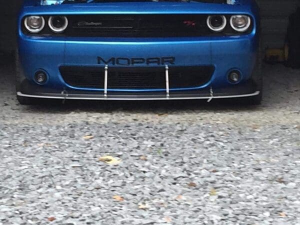 A blue car is parked in a garage