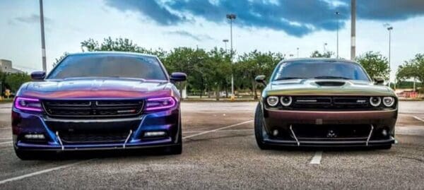 Two cars parked side by side in a parking lot