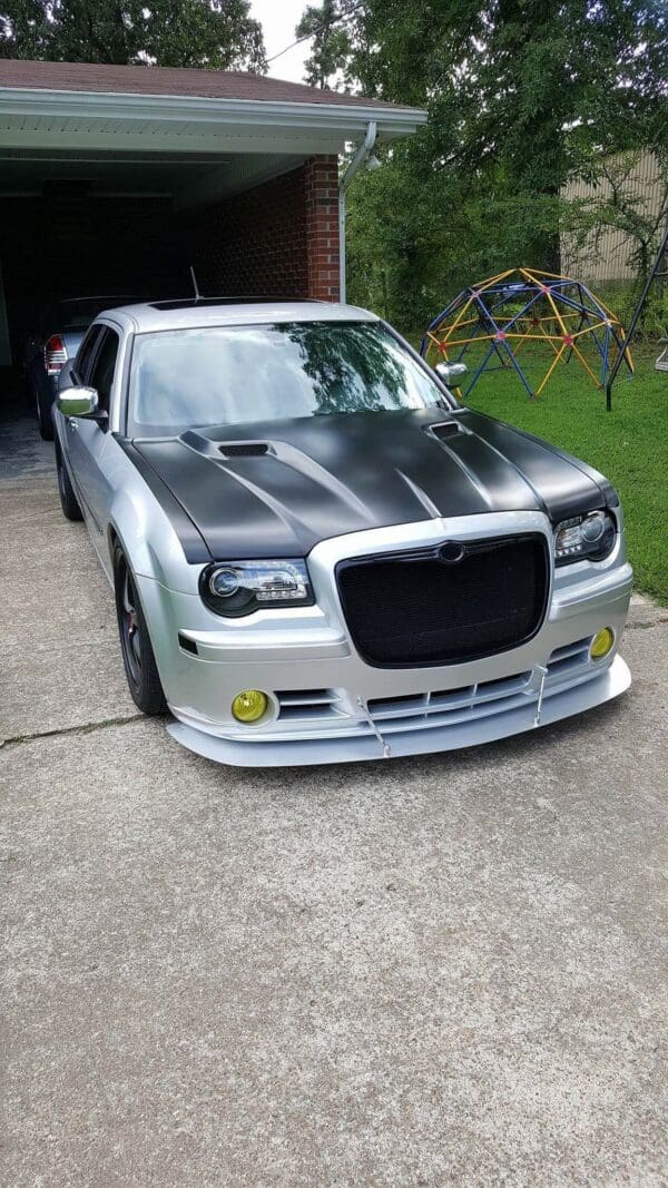 A silver and black car parked in a driveway