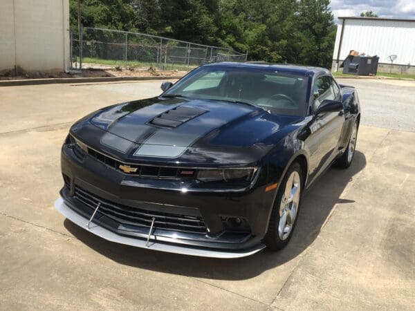 A black chevrolet camaro parked in a parking lot