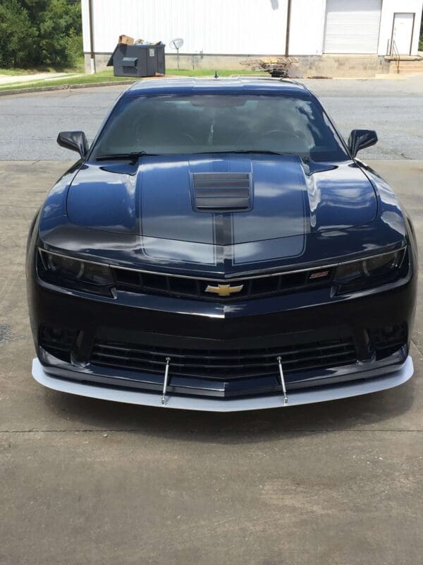 A black chevrolet camaro parked in a parking lot