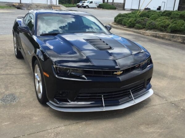A sleek black Chevrolet Camaro is parked in a parking lot.