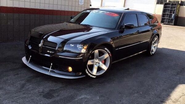 A black car parked in a parking lot