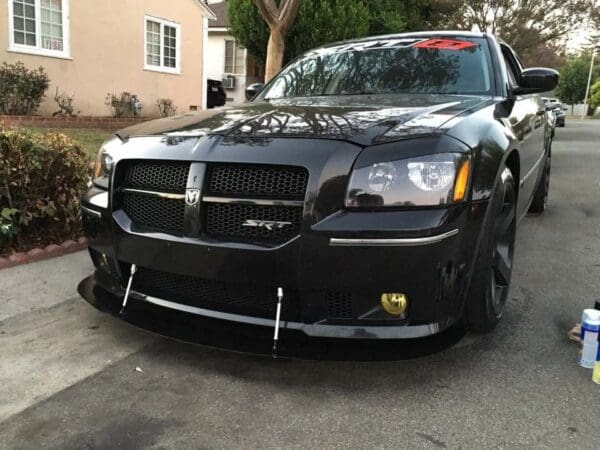 A black car parked in front of a house