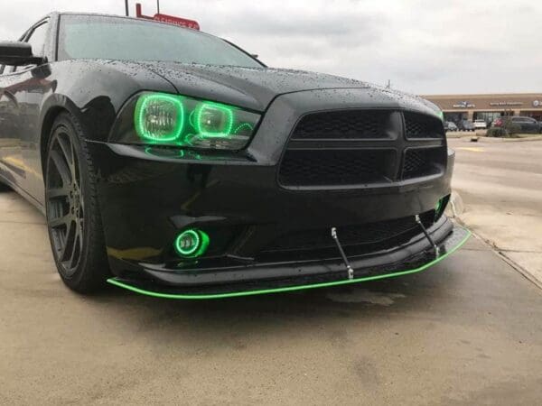 A black car with green lights on it