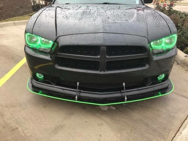 A black car with green lights on it