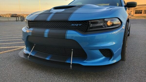 A blue and black car parked in a parking lot