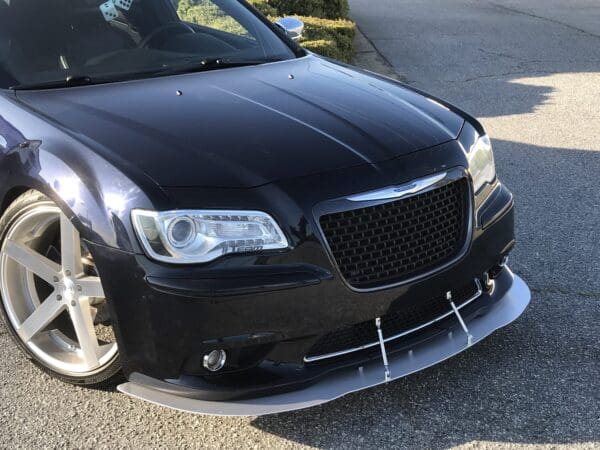 A black car parked on the side of a road