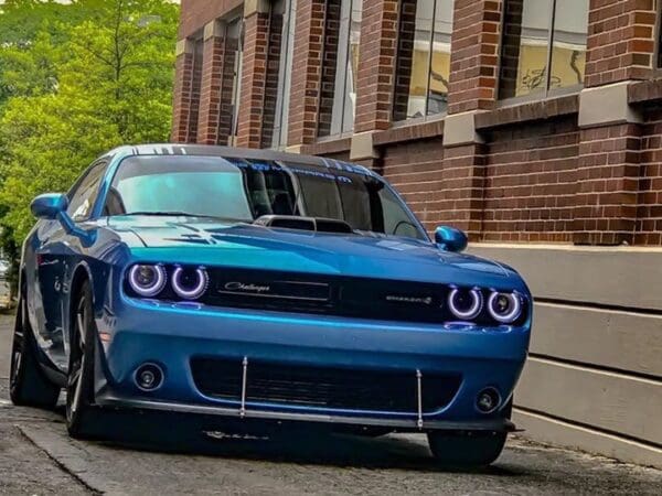 A blue car parked on the side of a street