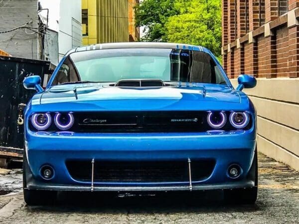 A blue car parked on the side of a road