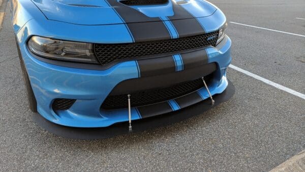 A blue and black car parked in a parking lot