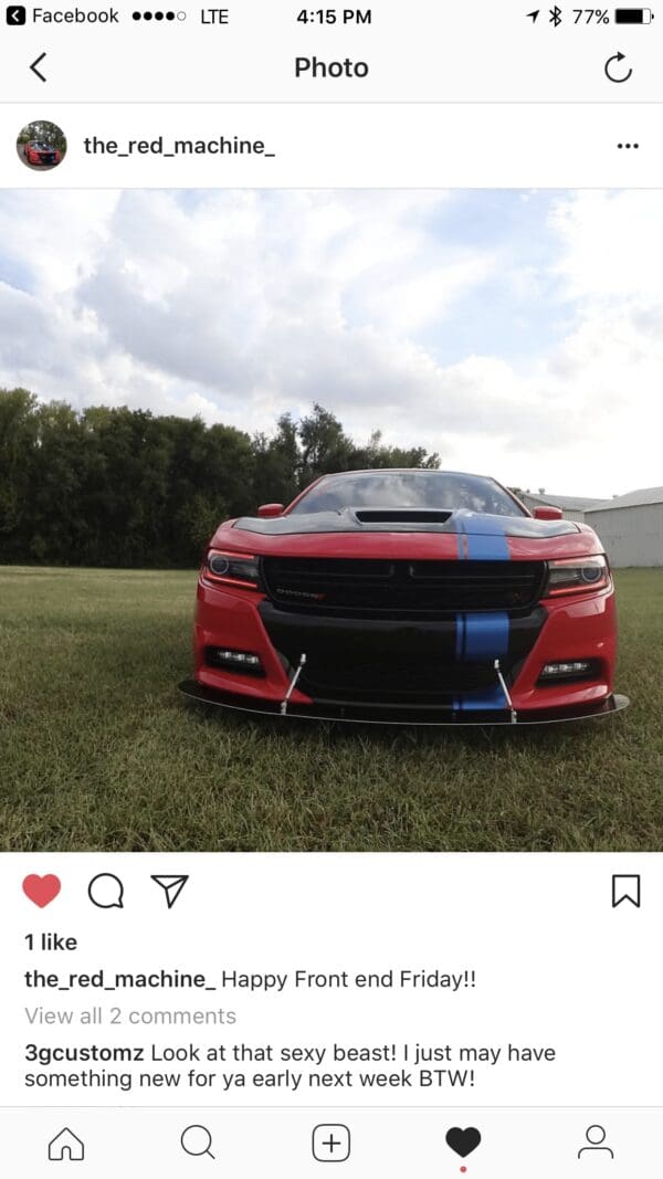 A red sports car parked in a field