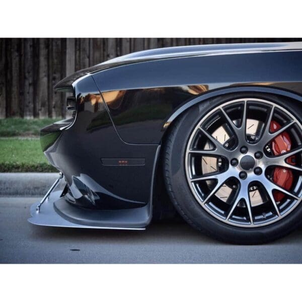 A close up of a car's wheels on a street