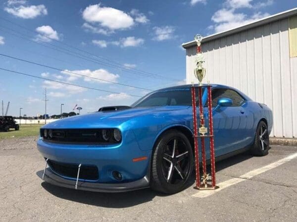 A blue car parked in front of a building