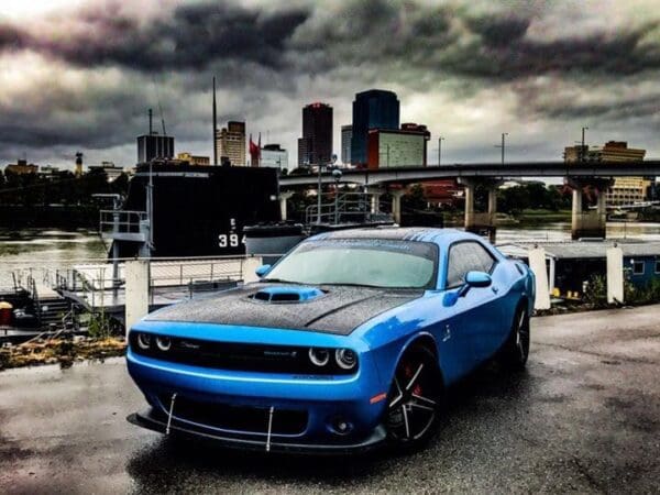 A blue car parked in a parking lot