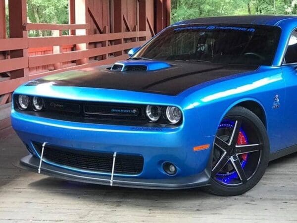 A blue and black car parked in a garage