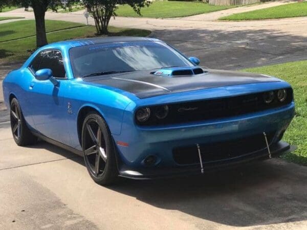 A blue car parked on the side of a road