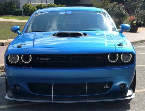 A blue car parked in a parking lot