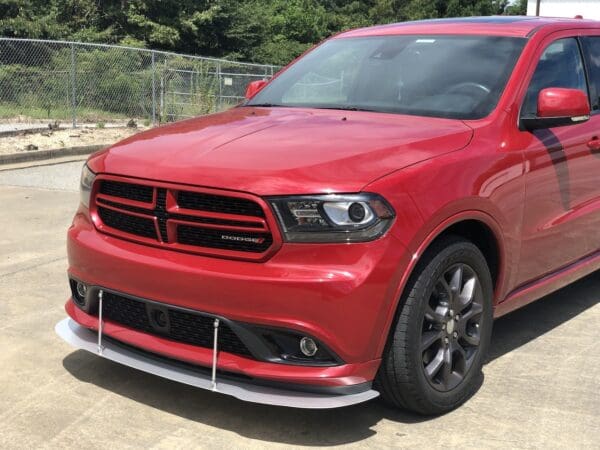 A red dodge suv parked in a parking lot