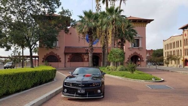 A black car parked in front of a building