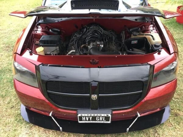 A red sports car with its hood open