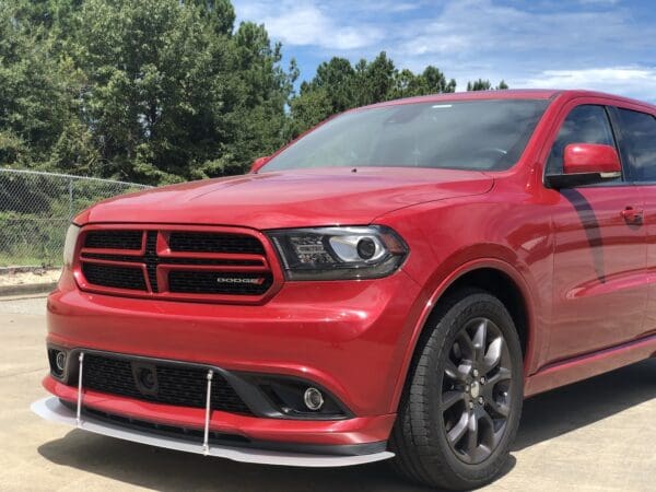 A red dodge suv parked in a parking lot