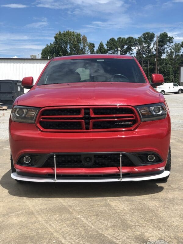 A red dodge charger parked in a parking lot