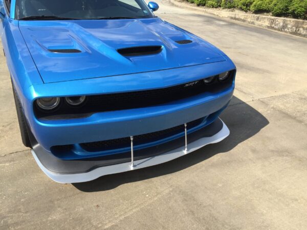 A blue SRT car parked in a parking lot, showcasing its front design and sporty features.