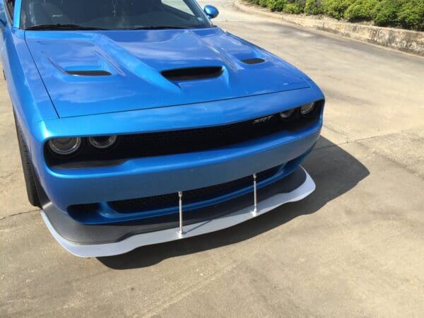 A blue car parked in a parking lot