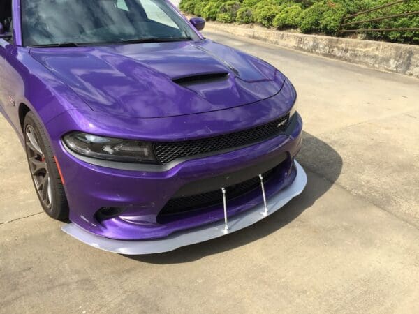 A purple car parked in a parking lot