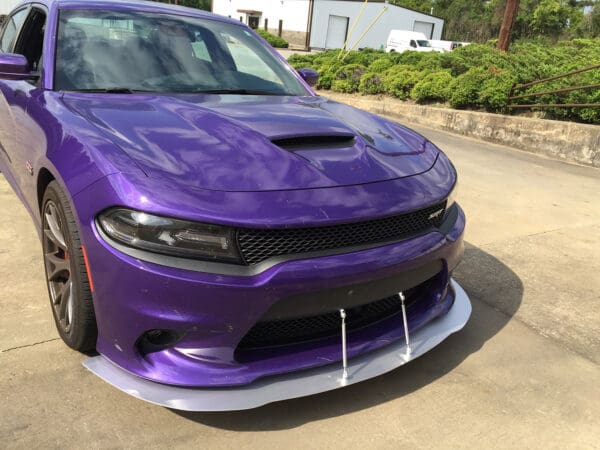 A purple car parked in a parking lot