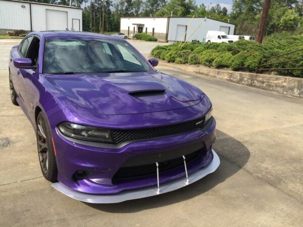 A purple car parked in a parking lot