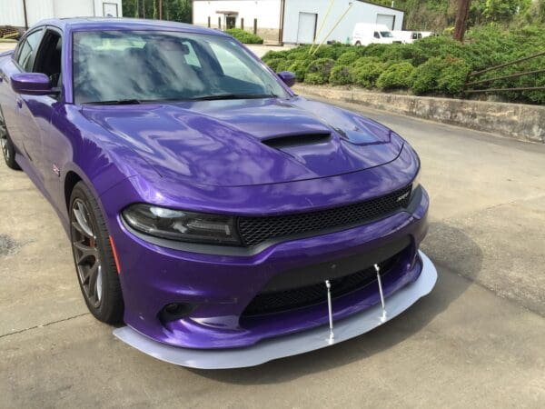 A purple dodge charger parked in a parking lot