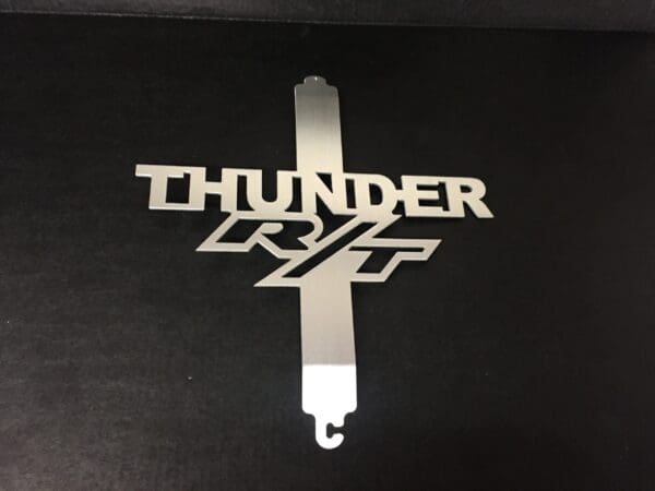 A metal hood prop with the word THUNDER RT