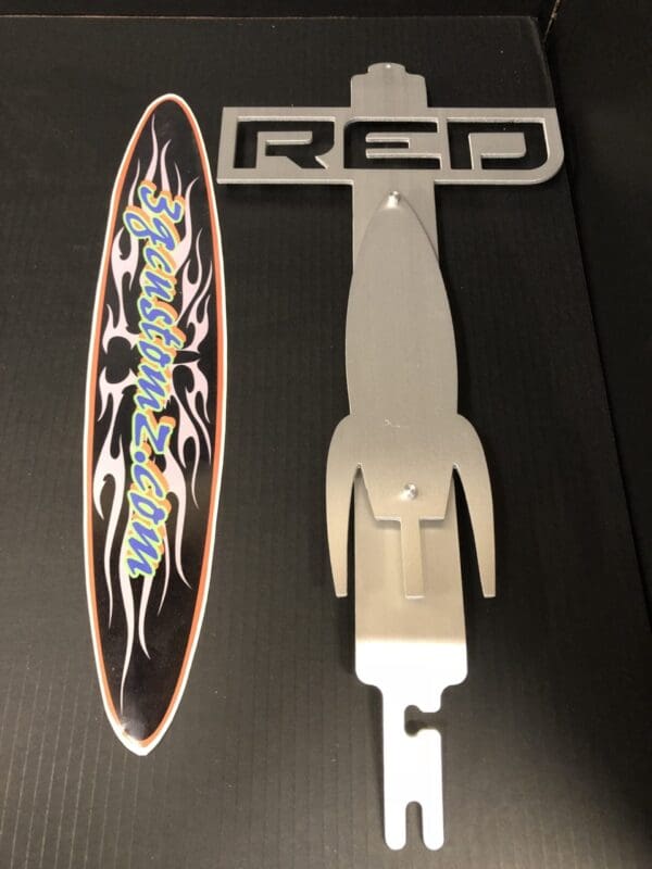 A metal hood prop with the word RED