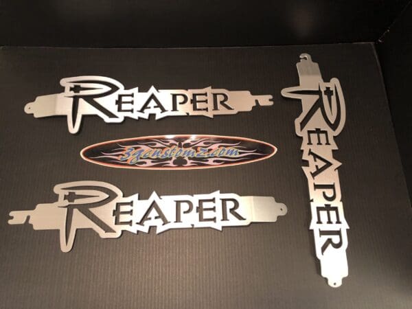 3 metal hood prop with the word RAPER