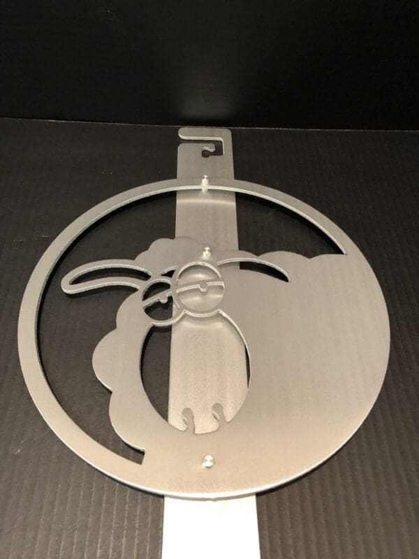 Silver cut-out emblem of a stylized rabbit on a black background.