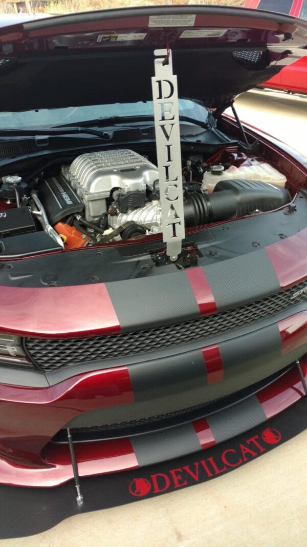 A red and black car with its hood up
