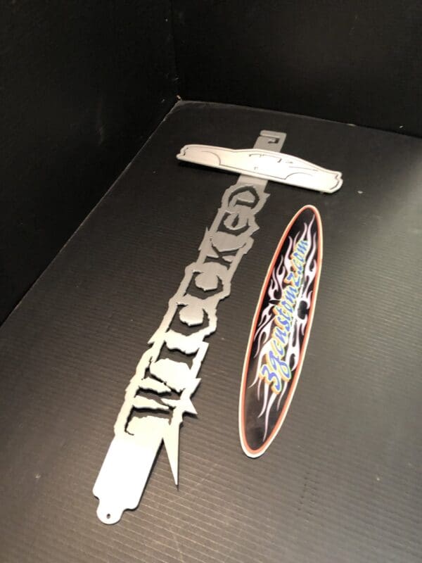 A metallic Hood Prop with the word Wiccked cut-out