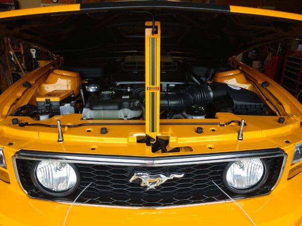 The hood of a yellow chevrolet camaro