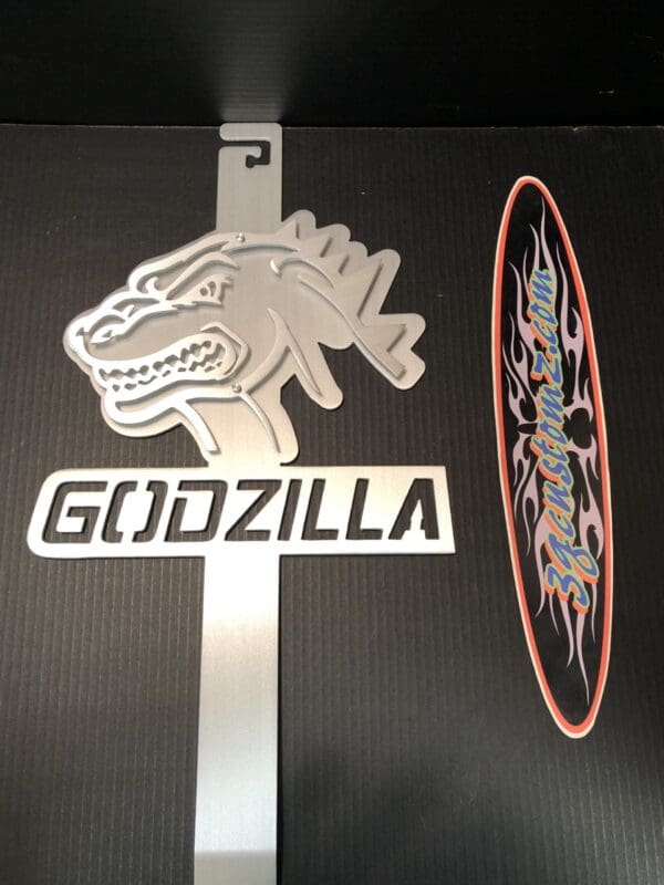 Silver Godzilla logo on a metallic Hood Prop