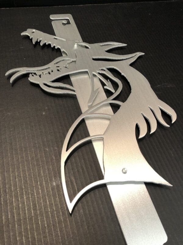 Silver dragon-shaped Hood Prop on a textured black background.