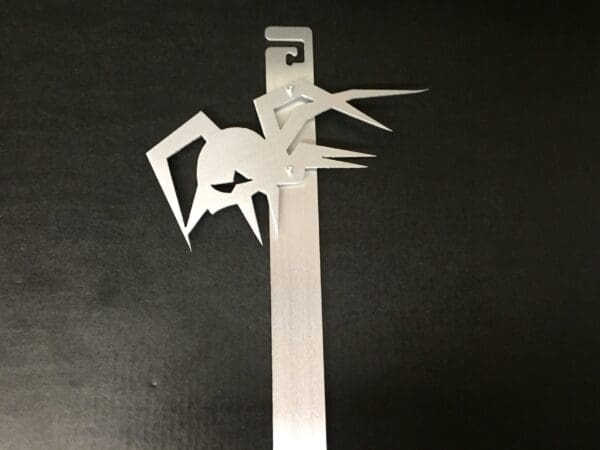 A metal Hood Prop with a spider design