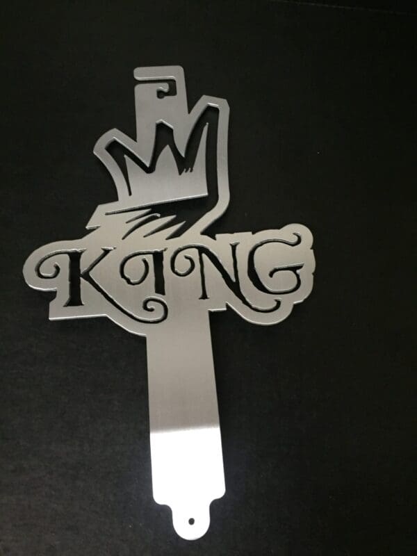 A metal hood prop with the word King on it