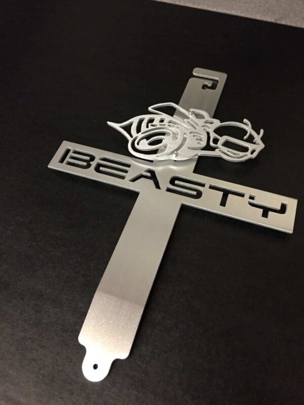 A metal hood prop with the word BEASTY designed on it