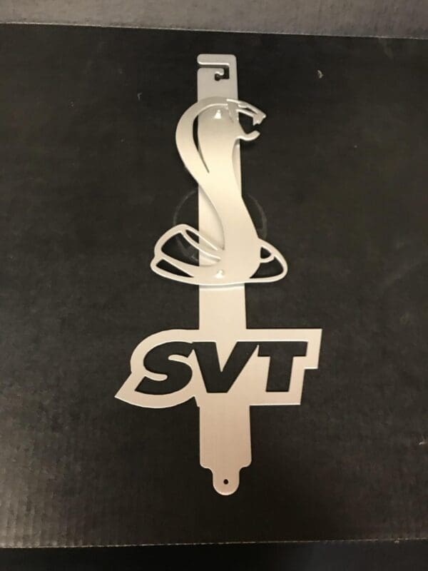 A metal hood prop with the word DUBWAGON designed on it