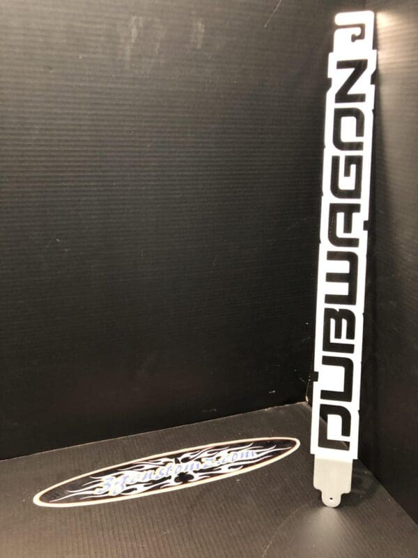 An open hood of a black car with a hood pop of a decepticon logo from transformers