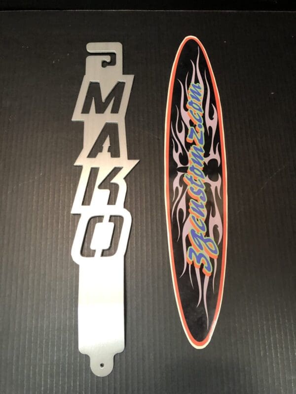 A metal hood prop with the word MAKO designed on it